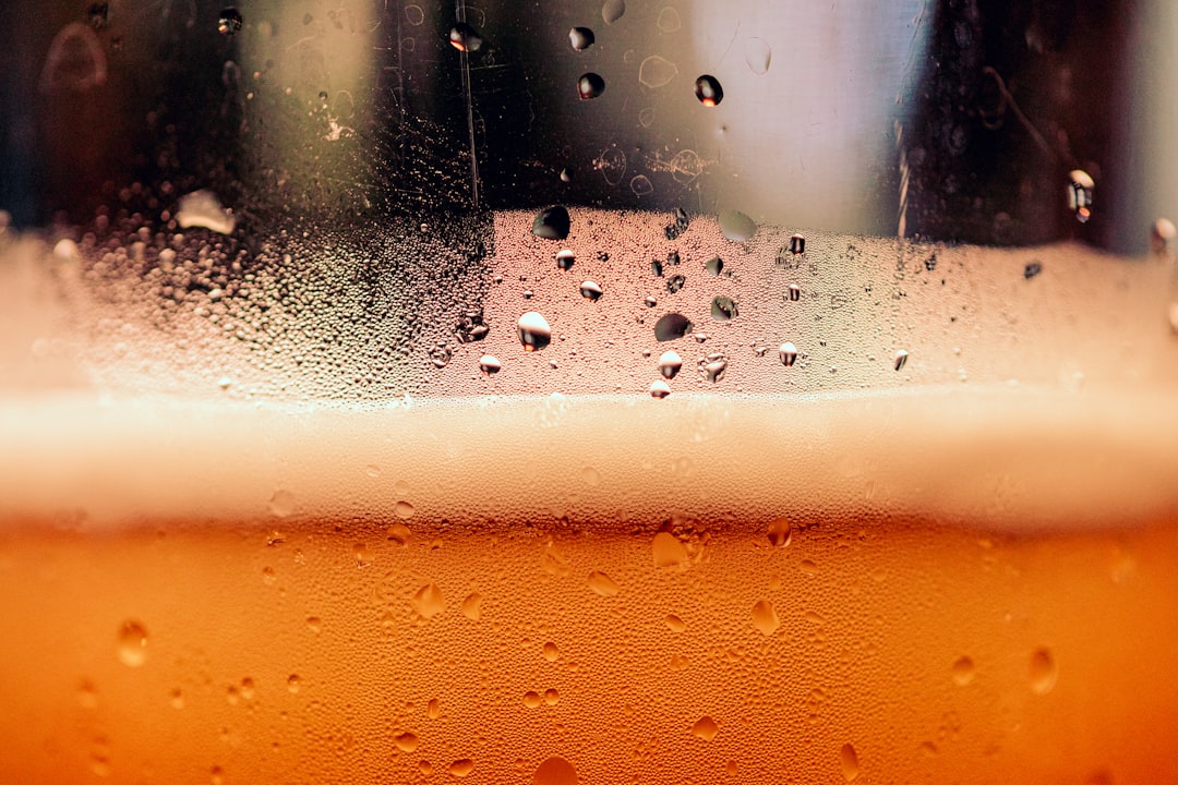 Golden craft beer in pint glass with perfect foam head