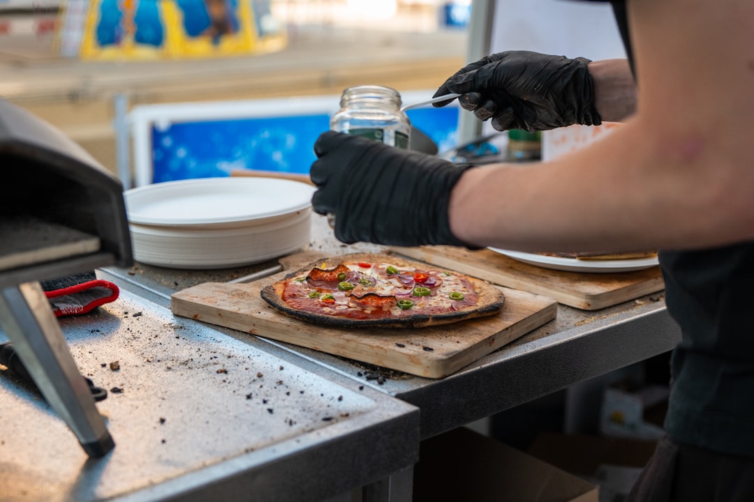 Fresh pizza dough and ingredients being prepared with flour visible