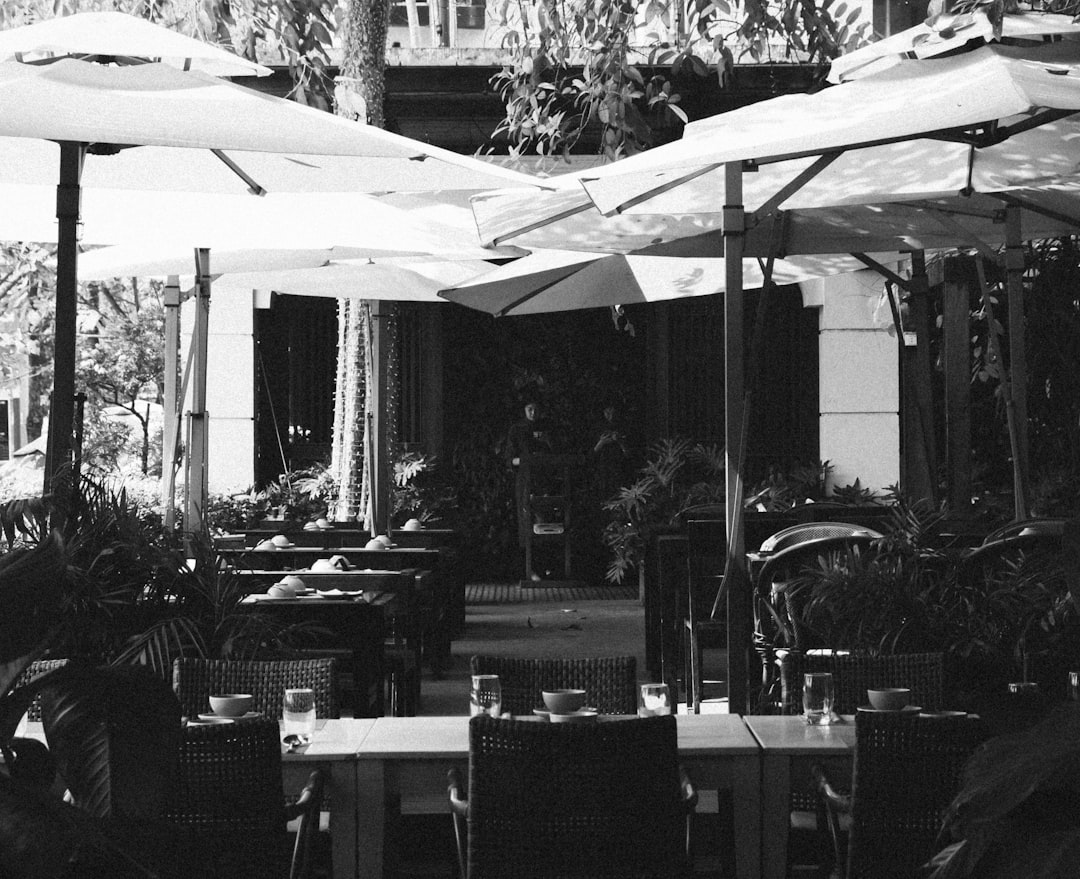 Beautiful outdoor patio restaurant setting with dining tables and food